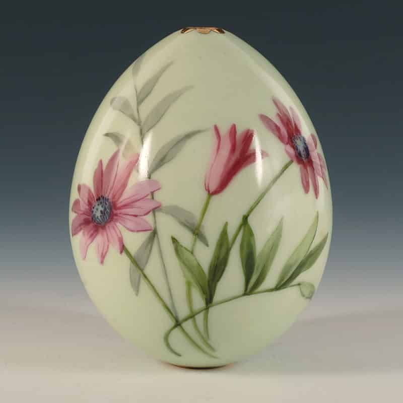 An antique Russian pale green ground porcelain Easter egg with marguerite daisies