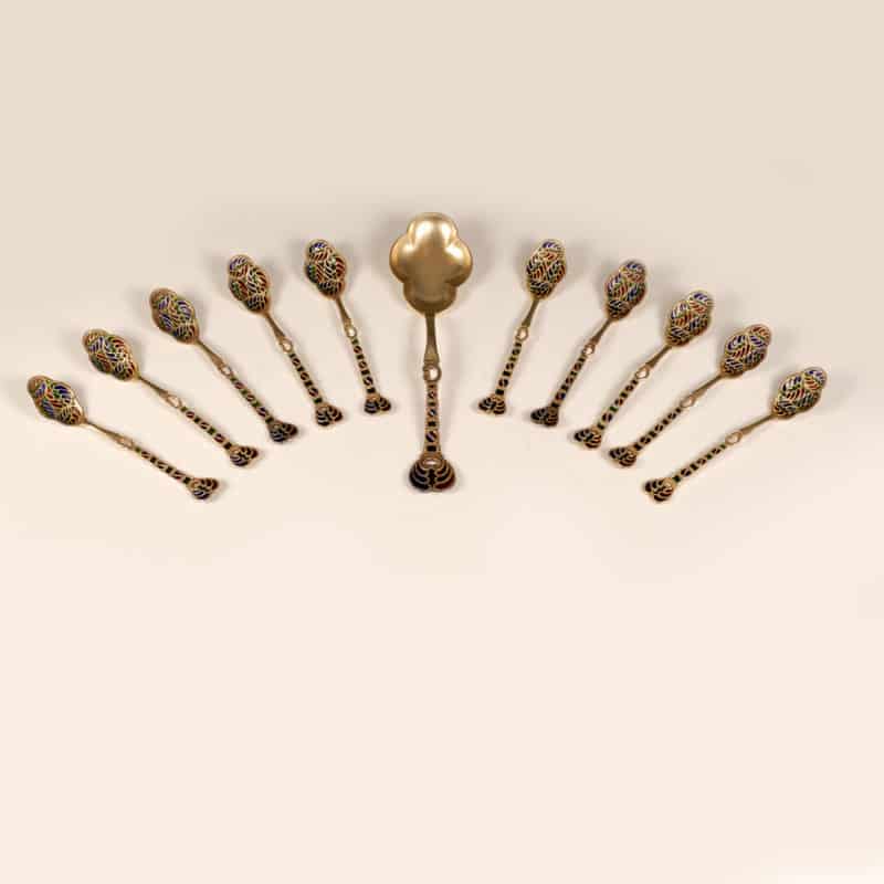 A Danish set of 10 plique-à-jour enamel teaspoons & a serving spoon, Peter Hertz