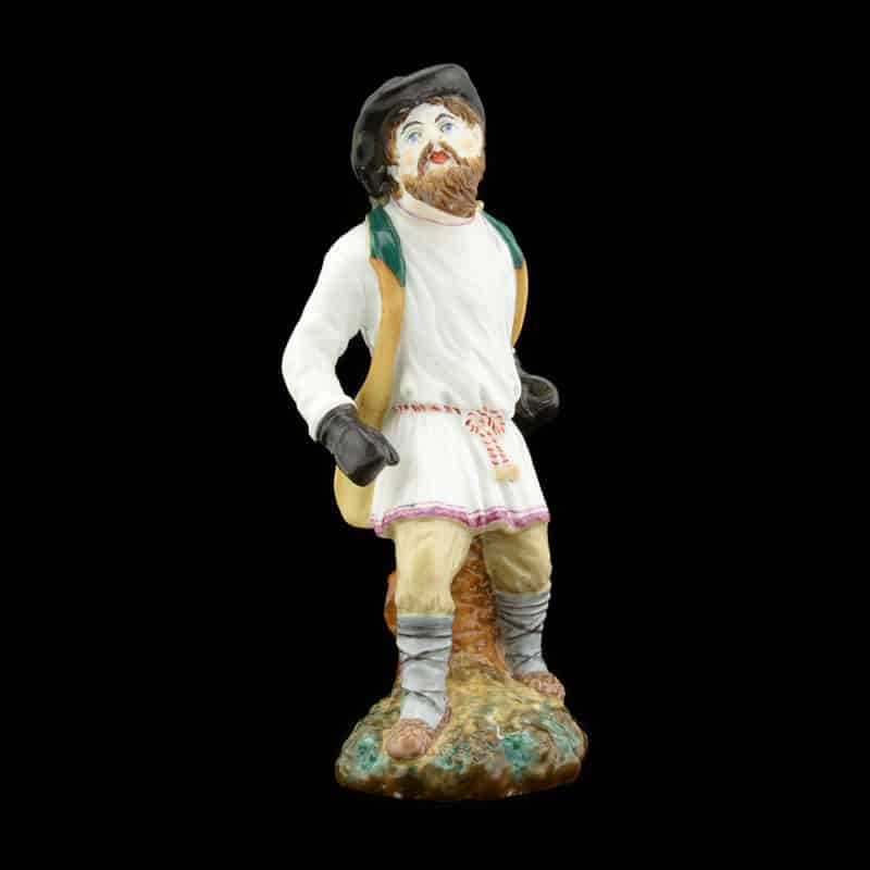 An antique Russian porcelain figure of a peasant boxer