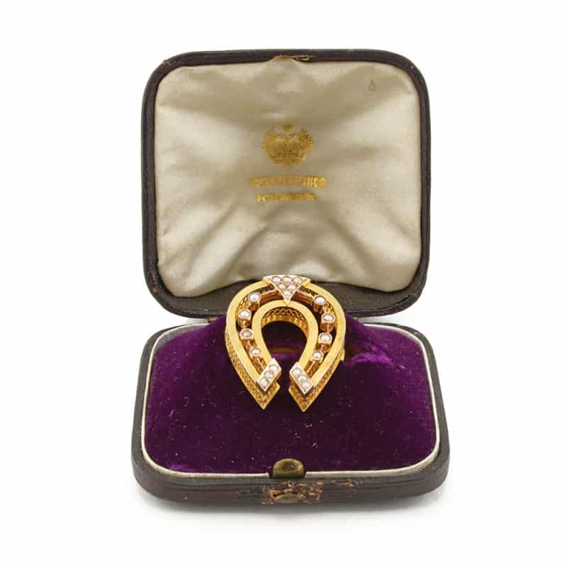 A Russian pearl-set gold horseshoe brooch