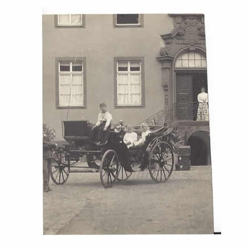 A photo of Tsarevich Alexei on the driver's seat of  carriage with two unidentified children